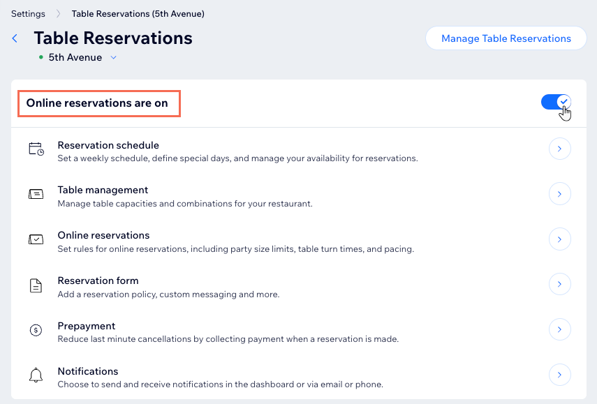 The Table Reservations Settings page in the Wix dashboard, clicking the online reservations toggle to turn it on